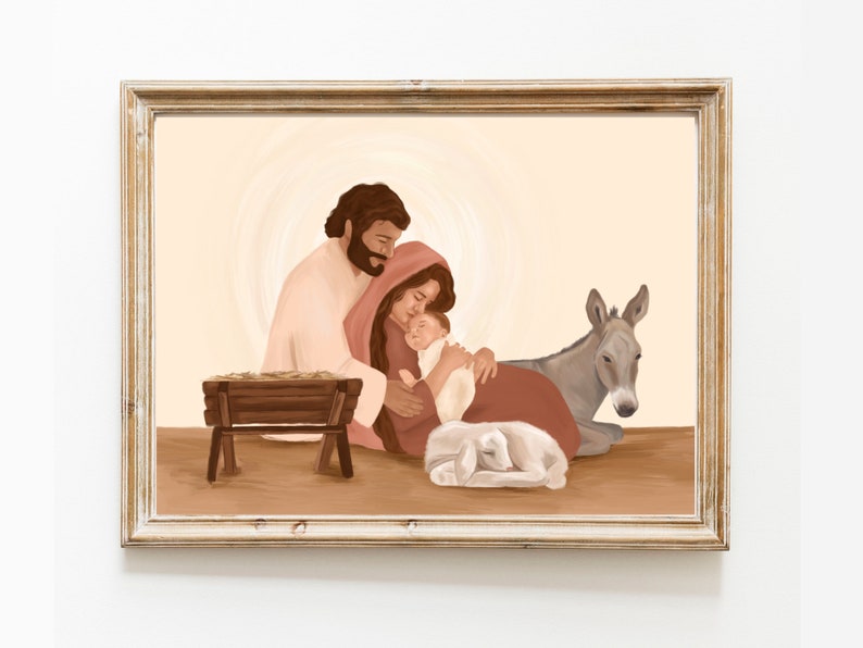 May include: A framed illustration depicting the Nativity scene. The artwork features a family with a baby, a donkey, and a lamb. The color palette includes soft browns, reds, and creams, creating a warm and comforting atmosphere. The frame is a light, distressed wood.