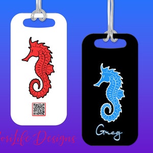 May include: Two luggage tags with a seahorse design. One tag is white with a red seahorse and a QR code. The other tag is black with a blue seahorse and the name "Greg" written in white.