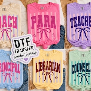 May include: Six short-sleeved t-shirts in cream, pink, lavender, light blue, yellow, and mint green. Each shirt features vertical stripes, a bow graphic, two stars, and the text COACH, PARA, TEACHER, PRINCIPAL, LIBRARIAN, or COUNSELOR.