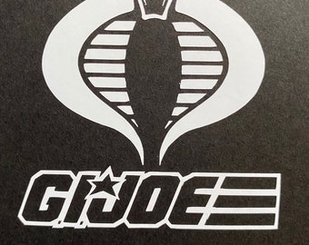 May include: A white Cobra logo with a white star and the text "G.I. JOE" on a black background.