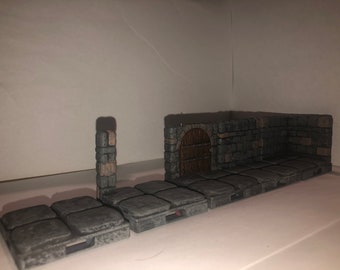 May include: A set of grey stone dungeon tiles with a brown wooden door and stone archway. The tiles are designed for tabletop role-playing games.