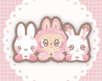May include: Three cute cartoon animals, a pink sheep and two white rabbits, are holding hearts in their paws. They are all smiling and have sparkly eyes. The background is a pink and white checkered pattern.