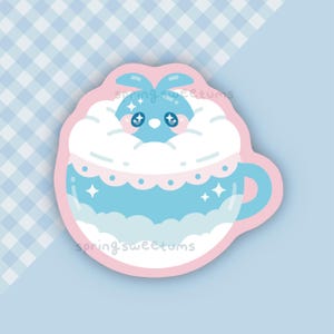 May include: A sticker featuring a blue bunny in a blue teacup with white clouds and star accents. The teacup is light blue with a pink border. The text "springsweetums" is visible on the sticker.