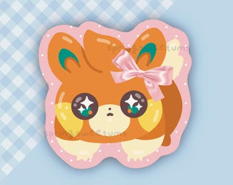 Peut inclure: Un autocollant représentant un animal de dessin animé avec une fourrure orange, de grands yeux étincelants et un nœud rose. L'autocollant a une bordure rose avec des pois blancs et le texte "spring sweetums". Le fond est bleu clair avec un motif à carreaux.