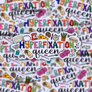 May include: A colorful sticker with the text "HYPERFIXATION QUEEN" surrounded by various icons, including a pizza slice, a paintbrush, a potted plant, a dumbbell, a sandwich, a yarn ball, a game controller, a sewing needle, a music note, and a dice. The sticker is on a white background with a repeating pattern of the text "HYPERFIXATION QUEEN".