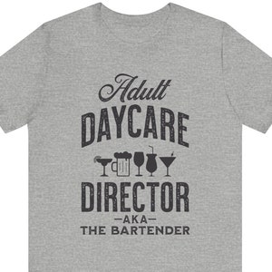 May include: Gray t-shirt with the text "Adult Daycare Director -AKA- The Bartender" and a row of drink icons.