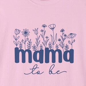 May include: Pink crew neck sweatshirt with a blue floral design and the words "mama to be". The sweatshirt has a Comfort Colors tag.