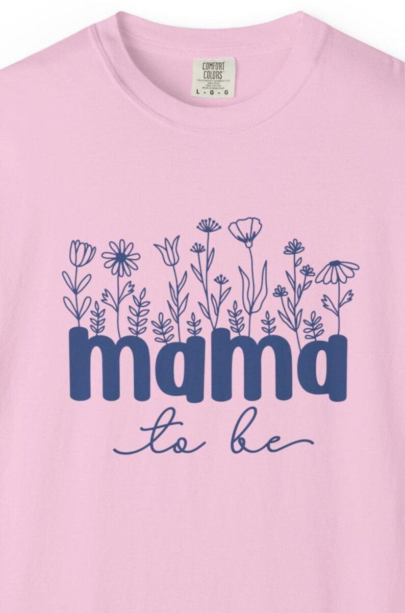 May include: Pink crew neck sweatshirt with a blue floral design and the words "mama to be". The sweatshirt has a Comfort Colors tag.
