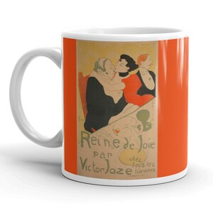 May include: White ceramic mug with a colorful image of three people. The image is a vintage poster for a play called "Reine de Joie" by Victor Joze. The text on the poster reads "chez tous les libraires".