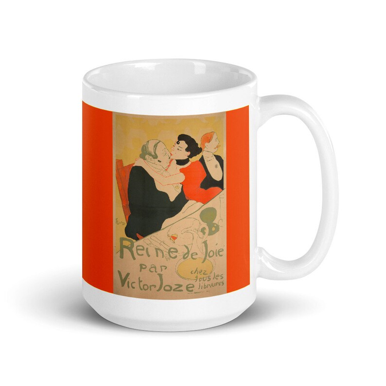 May include: White ceramic mug with a colorful image of a vintage poster for a play called "Reine de Joie" by Victor Joze. The poster features three people in a scene with a red background.