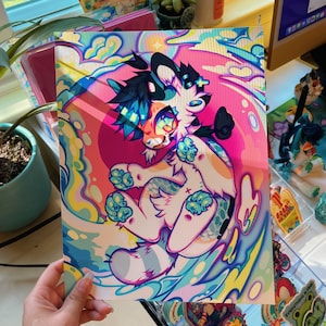 May include: A colorful print of a cartoon animal with blue, pink, and white fur. The animal is surrounded by swirling blue and yellow waves. The print has a vibrant, psychedelic style.