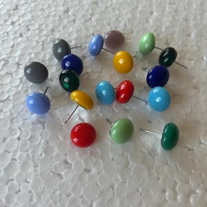 May include: A white ceramic mug with a black handle and the text "But First, Coffee" in a black, handwritten-style font. The mug is on a white surface.