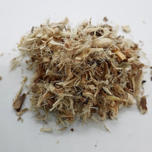 May include: A pile of dried, light brown, shredded plant material. The material is fibrous and has a slightly rough texture.