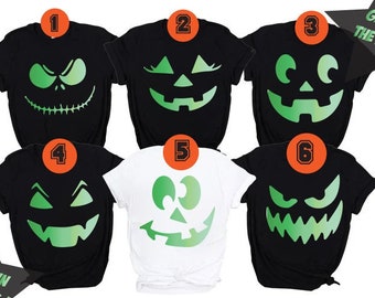 May include: Six black and white t-shirts with glow-in-the-dark green pumpkin faces. The shirts are numbered 1 through 6. The text "Glow in the Dark!" appears on the image.
