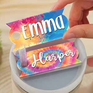 May include: Two colorful personalized drink labels with tie-dye and watercolor designs. The top label says "Emma" and the bottom label says "Harper".