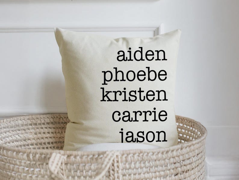 May include: White pillow with black text that reads "aiden phoebe kristen carrie jason".
