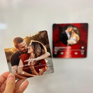 May include: A square photo print featuring a couple embracing, with the text "Through Every Storm" and a music player interface. A second print shows a couple in formal wear. The prints are likely personalized gifts.