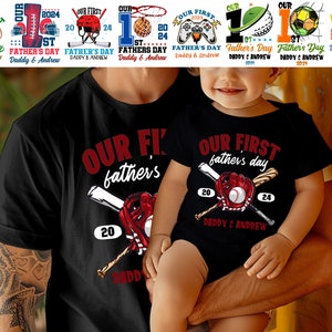 May include: A black t-shirt with the text "Our First Father's Day" and a baseball graphic. A smaller black t-shirt with the same text and graphic is worn by a child.
