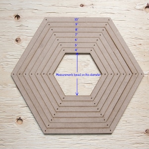 May include: A collection of light brown, hexagonal wooden templates, with sizes from 10 cm to 25 cm in diameter. The sizes are labeled in inches. The text "Measurements based on this diameter" is also present.