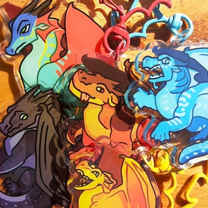 May include: A set of six colourful dragon character keychains. The dragons are made of clear acrylic and feature different colours and designs. The keychains are attached to metal rings.