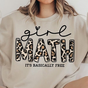 May include: A beige sweatshirt with a black and brown leopard print graphic that says "girl math it's basically free".