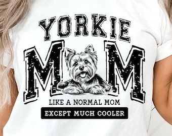 May include: White t-shirt with a black graphic design that says "Yorkie Mom" with a Yorkshire Terrier dog illustration. The text below the illustration says "Like a normal mom except much cooler."