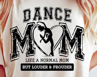 May include: A white t-shirt with a black graphic design that says "Dance Mom" with a silhouette of a dancer in a heart. The text below the graphic says "Like a normal mom but louder & prouder".