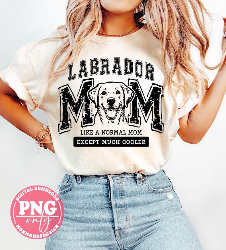 May include: A white t-shirt with a black graphic that says "Labrador Mom" with a Labrador Retriever dog illustration. The text below the graphic says "Like a normal mom except much cooler."