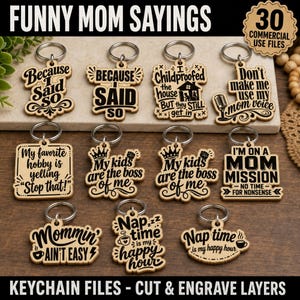 May include: A collection of eleven wooden keychains featuring black engraved text with funny sayings about parenting. Each keychain includes a metal ring and displays phrases like Because I Said So, My kids are the boss of me, and Nap time is my happy hour.