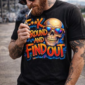 May include: Black t-shirt with a colorful graphic of a skull wearing sunglasses and the text "F**k Around and Find Out". The design features orange, blue, and yellow hues. The shirt is short-sleeved.