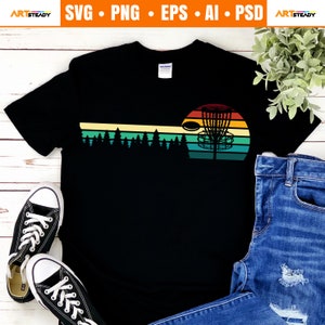 May include: Black t-shirt featuring a disc golf design. The graphic includes a sunset with a disc golf basket, a disc, and a forest silhouette. The shirt also has the text "ARTSTEADY" and "SVG • PNG • EPS • AI • PSD".