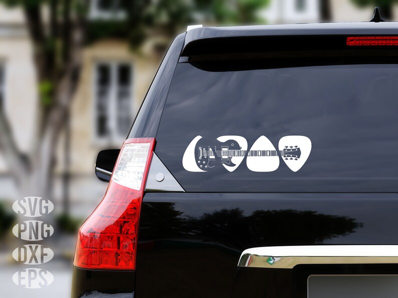 May include: A black car with a white guitar and guitar picks sticker on the back window. The sticker is in the shape of guitar picks and features a silhouette of a guitar.