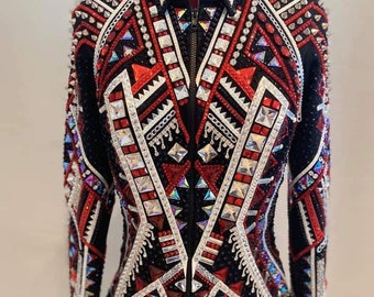 May include: A black show jacket with a red, white, and black geometric pattern. The jacket is embellished with rhinestones and studs.