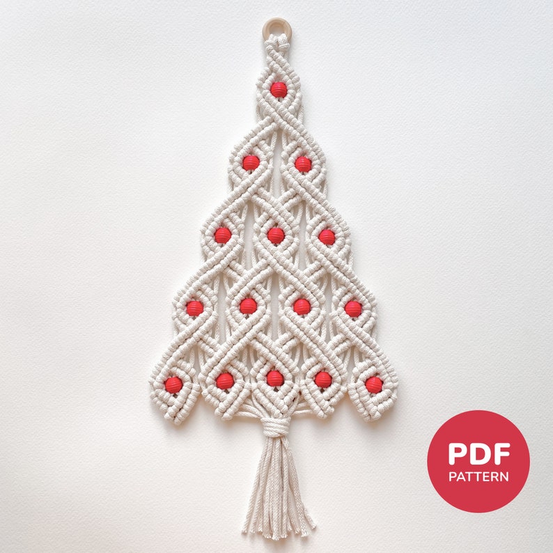 May include: White macrame Christmas tree wall hanging with red beads. The tree has a tassel at the bottom. The image includes the text "PDF PATTERN".