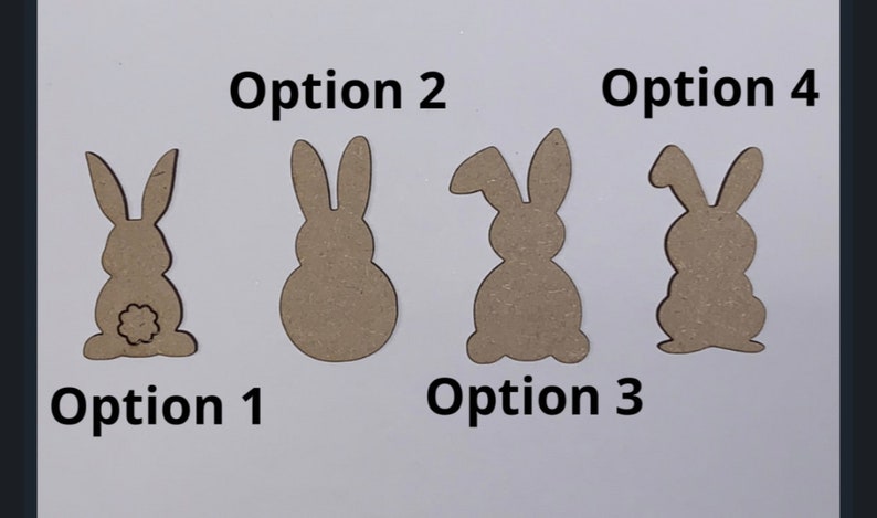 May include: Four different wooden bunny cutout options for crafts. The bunny cutouts are all brown and have different shapes and sizes. Option 1 has a tail, option 2 is round, option 3 has a long ear, and option 4 is a simple bunny shape.