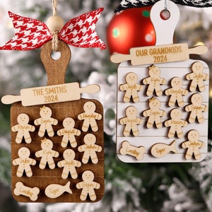 May include: Two wooden Christmas ornaments. One is a cutting board shape with the text "THE SMITHS 2024" and gingerbread people. The other is a white cutting board shape with the text "OUR GRANDKIDS 2024" and gingerbread people. Both have decorative bows.
