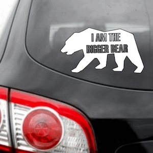 May include: White vinyl car sticker with a silhouette of a bear and the text "I AM THE BIGGER BEAR".