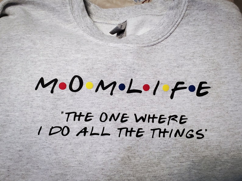 May include: Gray sweatshirt with black text that reads "M.O.M.L.I.F.E. "The One Where I Do All The Things"