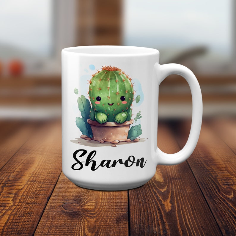 May include: White ceramic mug with a cartoon cactus illustration and the name "Sharon" printed on the front.