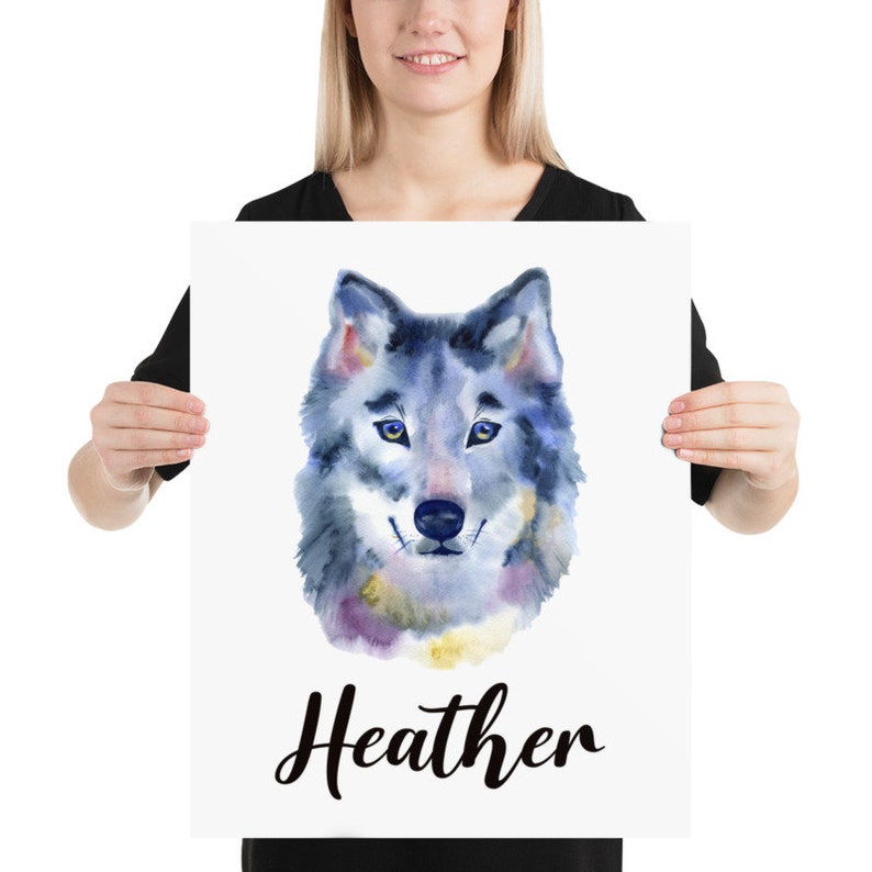 May include: A watercolor print featuring a wolf's head with blue, gray, and purple hues. The wolf has blue eyes and a friendly expression. The name "Heather" is written in cursive below the wolf illustration.
