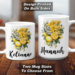 May include: Two white ceramic mugs with floral and lemon designs. One mug is smaller and says "Kelianne" in black script, the other is larger and says "Hannah". The mugs have a design printed on both sides. Text at the bottom says "Two Mug Sizes To Choose From".