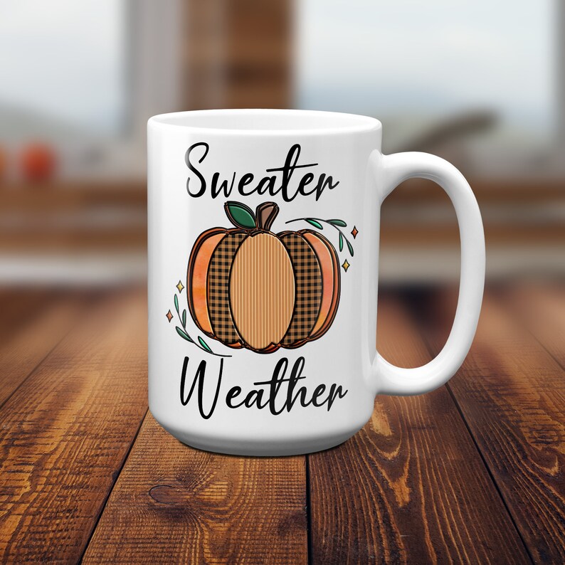 May include: White ceramic mug with a black and orange pumpkin design and the text "Sweater Weather".