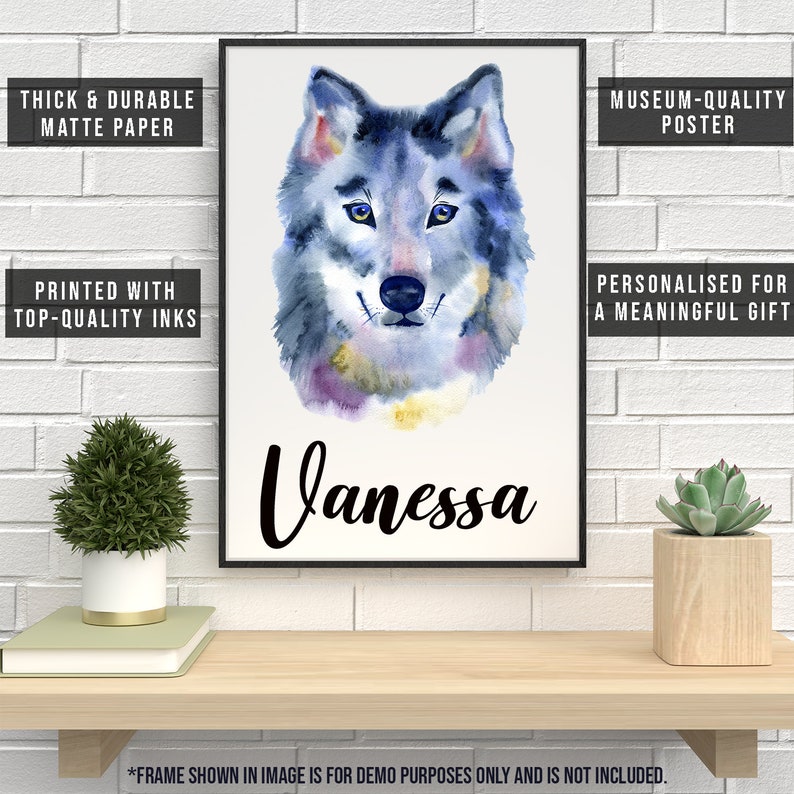 May include: A framed watercolor print of a wolf's face in shades of blue, purple, and yellow. The name "Vanessa" is written below the image in cursive. Text on the frame reads "Thick & Durable Matte Paper," "Printed with Top-Quality Inks," and "Museum-Quality Poster."