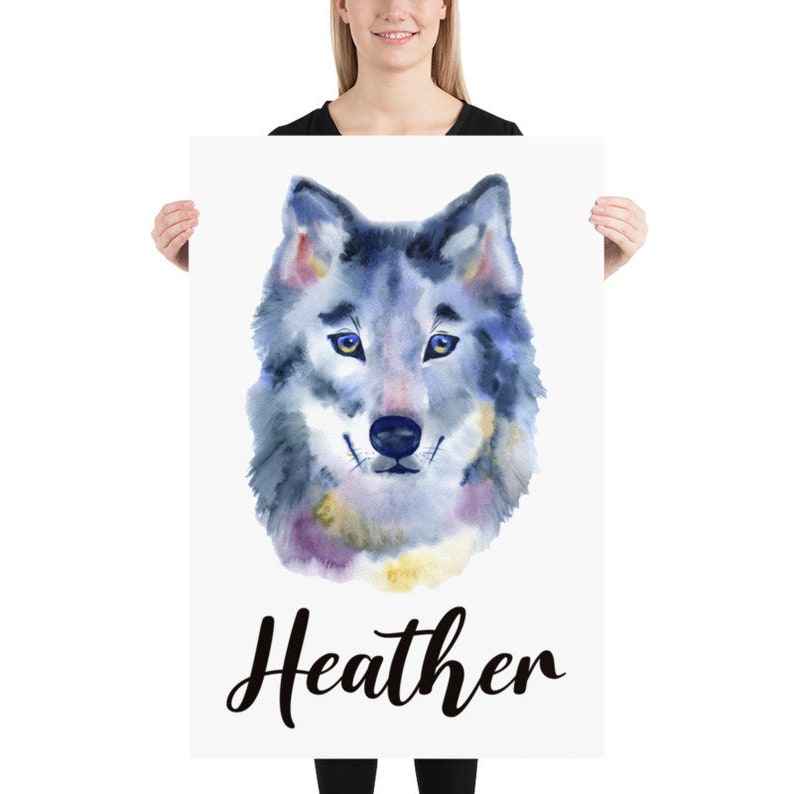 May include: A poster featuring a watercolor painting of a wolf's head. The wolf is depicted in shades of blue, gray, and purple, with yellow eyes. The name "Heather" is written in cursive script below the wolf.