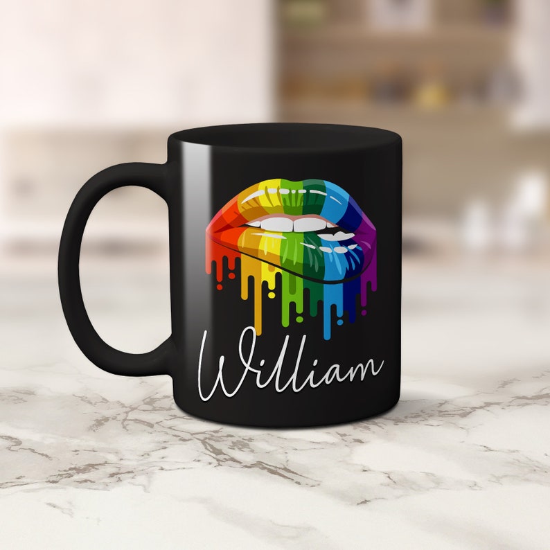 May include: Black coffee mug with a rainbow dripping lips design and the name "William" printed in white.