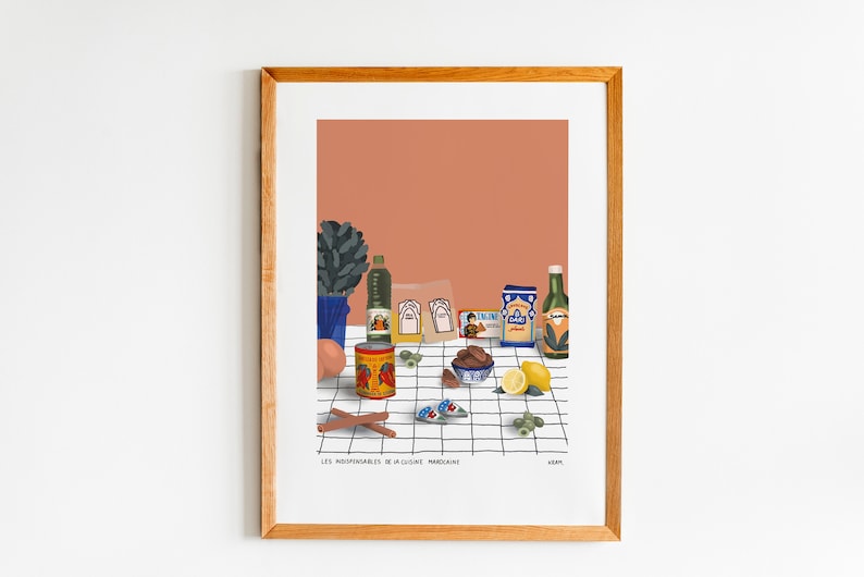 May include: A framed illustration of a still life featuring various ingredients for Moroccan cooking. The ingredients include olive oil, spices, dates, lemons, and a can of tomatoes. The text on the image reads "Les Indispensables de la Cuisine Marocaine".