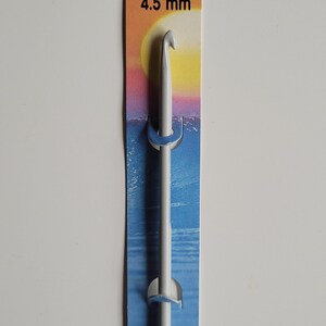May include: White plastic crochet hook with a 4.5 mm size, packaged on a blue and yellow card with the brand name "PONY" and the text "15 cm" and "# 45610 MADE IN INDIA".