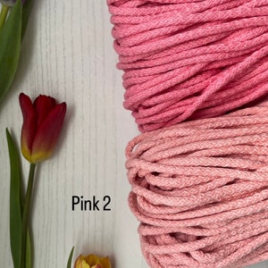May include: Two spools of pink cotton rope, one a lighter pink and the other a darker pink. The spools are labeled "Pink 1" and "Pink 2".