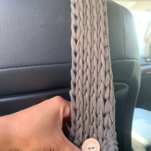 May include: A brown crocheted bag with a wooden button that says "Handmade with love".