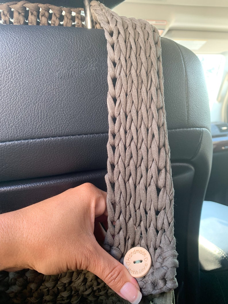 May include: A brown crocheted bag with a wooden button that says "Handmade with love".